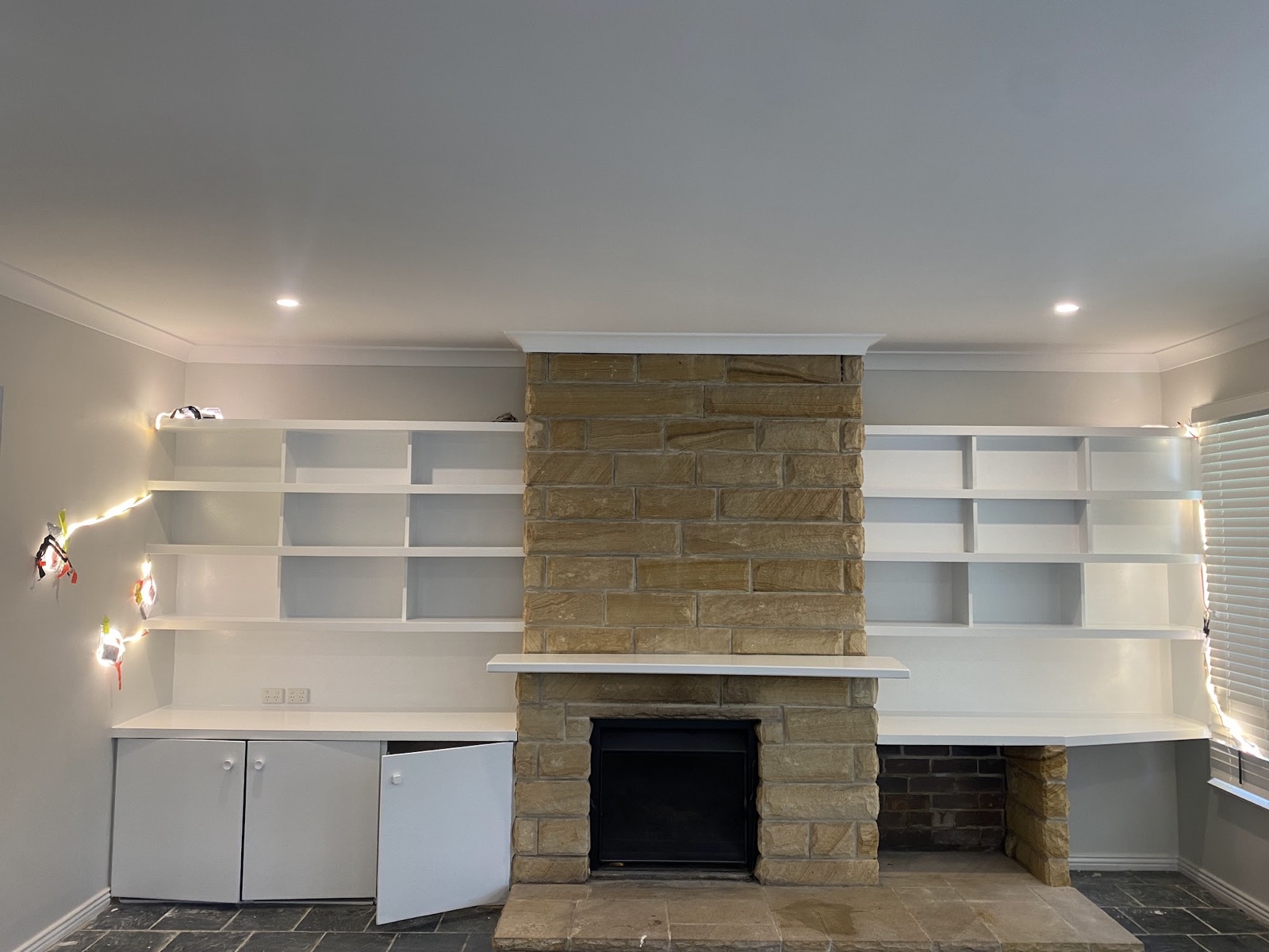 Built-ins and sandstone fireplace
